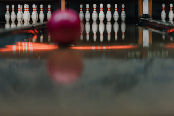 istock red bowling ball rolling to pins by alley 1001419930