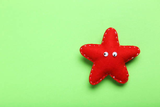 istock Decoration star with googly eyes on a green background 1001423958