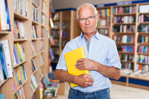 istock Happy elderly man in bookstore 1001426704