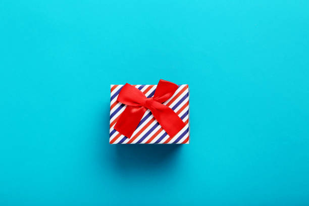 istock Gift box with ribbon on blue background 1001427030