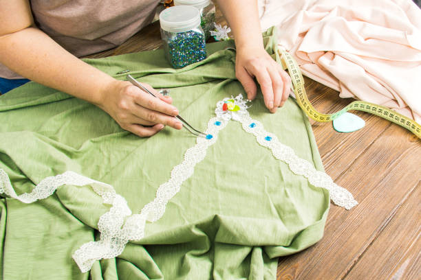 istock A woman is making jewelry, a home workshop. Female hands that create an accessory with beads and ribbons. Beauty, creativity, the concept of handicraft. 1001430990
