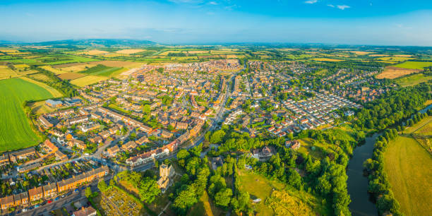 istock Aerial panorama over town river suburban homes surrounded by fields 1001431050