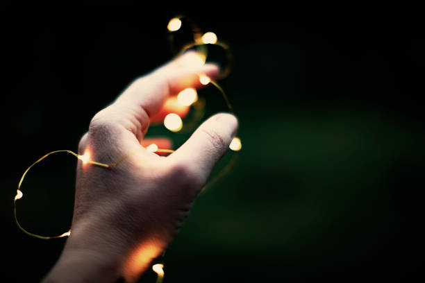 istock Christmas lights in woman hand 1001431056