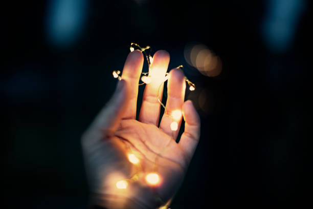 istock Christmas lights in woman hand 1001431116