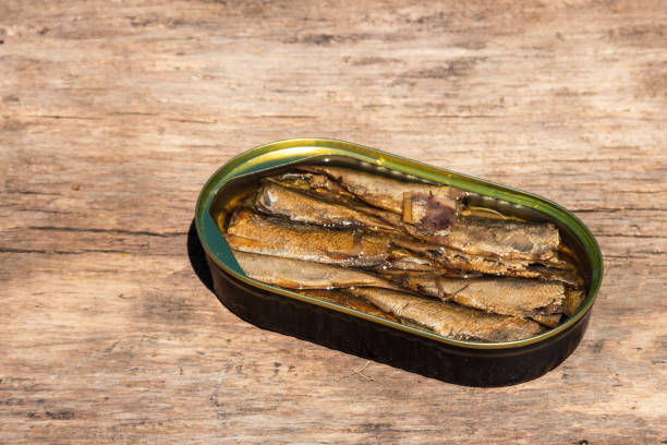 istock Open tin can of sprats on rustic wooden table 1001431278