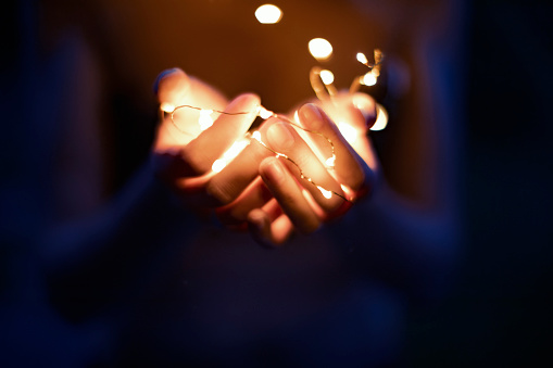 Christmas lights in woman hand