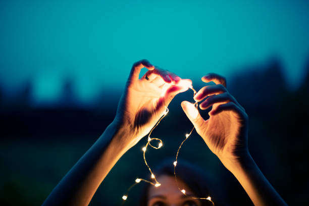istock Christmas lights in woman hand 1001433562