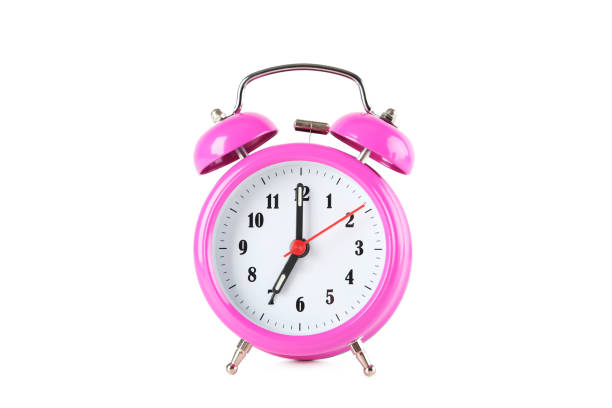istock Pink alarm clock isolated on a white 1001433788