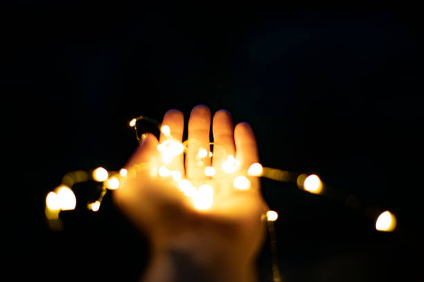 istock Christmas lights in woman hand 1001434050
