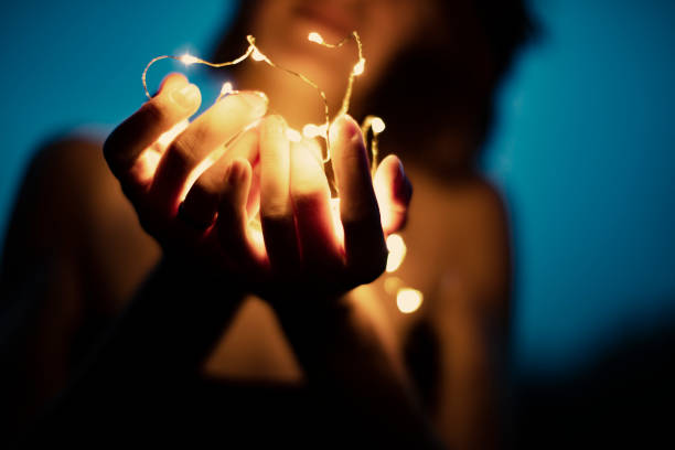 istock Christmas lights in woman hand 1001434058