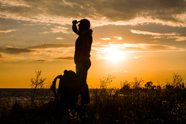 istock Tourist is looking afar at the seashore against the sunset 1001434202