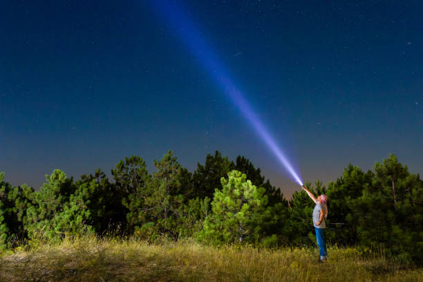 istock A man shines the night sky with a flashlit 1001434260