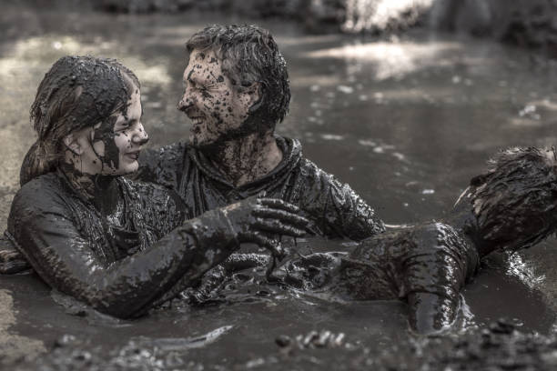 istock Family having sporty fun at a public mud run obstacle course 1001434590