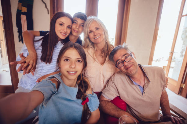 istock Happy multi-ethnic multi-generation family taking selfies together at home 1001434596