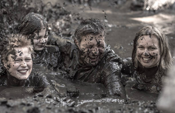 istock Family having sporty fun at a public mud run obstacle course 1001434682