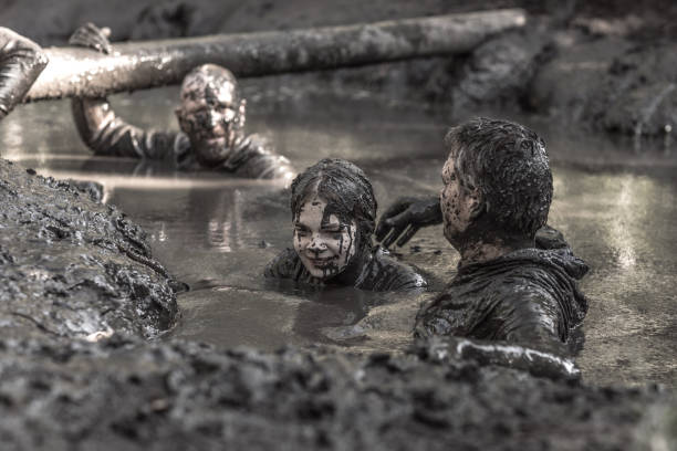 istock Family having sporty fun at a public mud run obstacle course 1001434714