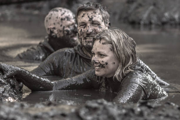 istock Family having sporty fun at a public mud run obstacle course 1001434808