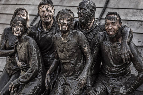 istock Family having sporty fun at a public mud run obstacle course 1001434952