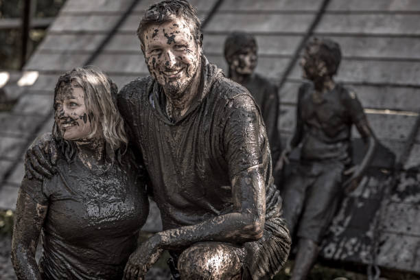 istock Family having sporty fun at a public mud run obstacle course 1001435012