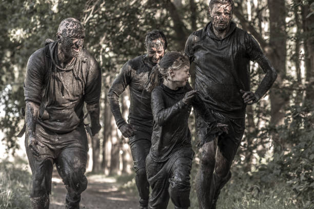 istock Family having sporty fun at a public mud run obstacle course 1001435334