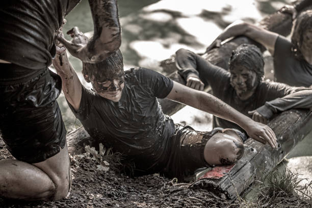 istock Family having sporty fun at a public mud run obstacle course 1001435456