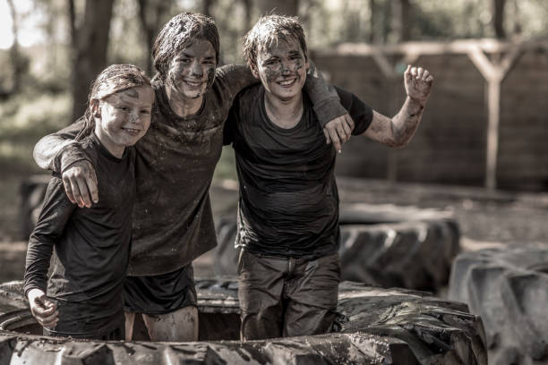 istock Family having sporty fun at a public mud run obstacle course 1001437782