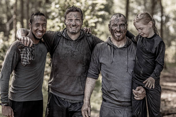 istock Family having sporty fun at a public mud run obstacle course 1001438130