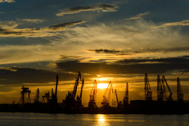 istock Cranes silhouette in the Varna Harbor at sunset. 1001438348