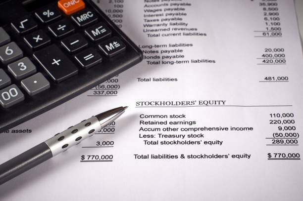 istock balance sheet, calculator and pen 1001465102