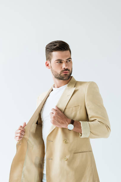 istock Handsome bearded man straightening his jacket isolated on white background 1001473274