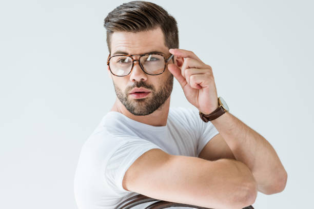 istock Fashionable confident man fixing his glasses isolated on white background 1001473524
