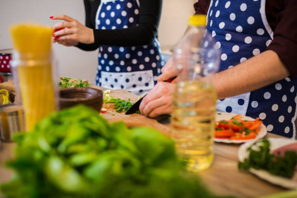 istock Smiling young couple cooking food in the kitchen 1001473616