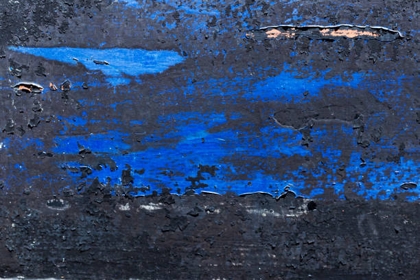 Texture of colourful metal background with a peeling cracked layers of paint.