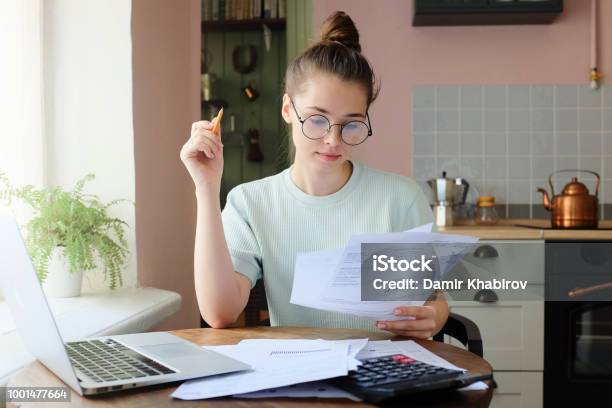 Indoor Picture Of Young European Female Sitting At Home At Table Stock Photo - Download Image Now