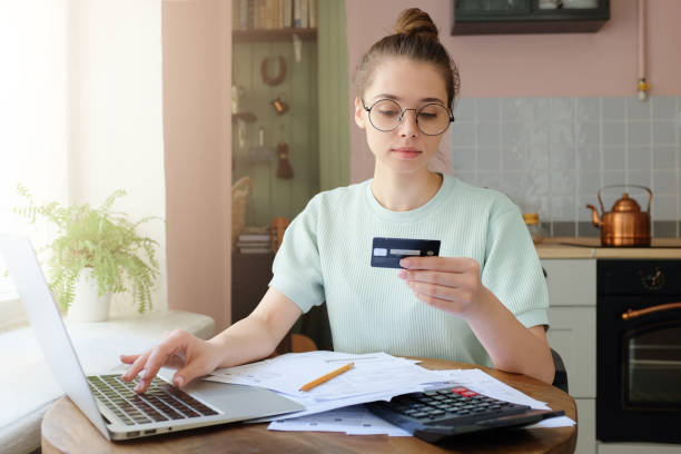 istock Young beautiful woman making transaction using online bank application 1001479874
