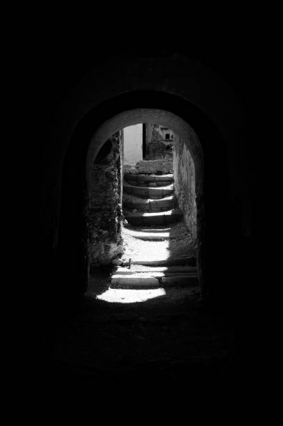 istock End of tunnel looking into light and stairs 1001490094