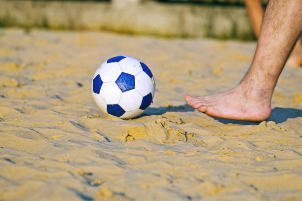 istock play football on the beach 1001490366