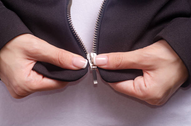 istock Woman in black jacket zipper macro 1001491098