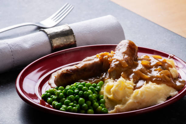 istock Bangers and mash with peas and onion gravey 1001502386