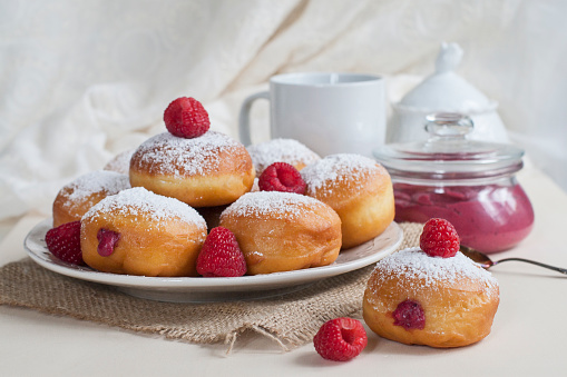 Bomboloni or berliners - doughnuts with berry curd.
