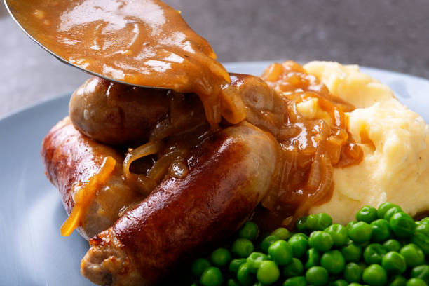 istock Bangers and mash with peas and onion gravey 1001506616