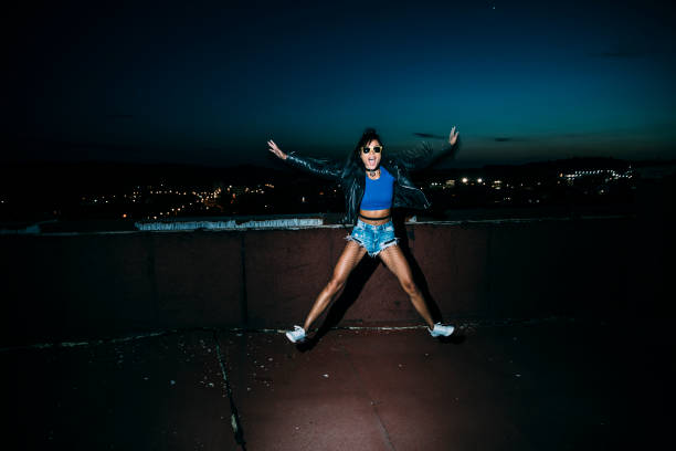 istock Cheerful young woman jumping 1001506638