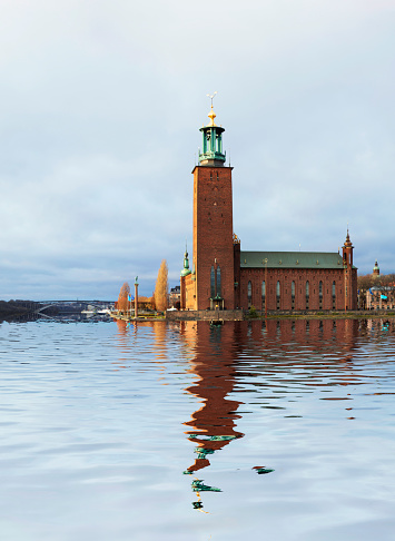 Stockholm City Hall, with its spire featuring the golden Three Crowns, is one of the most famous silhouettes in Stockholm, Sweden.