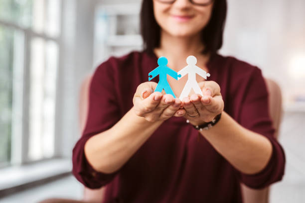 istock Happy woman smiling and holding two stickmen 1001509272