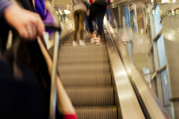 istock Point Of View Of Going Up An Escalator, With Luggage,Anonymous 1001509488