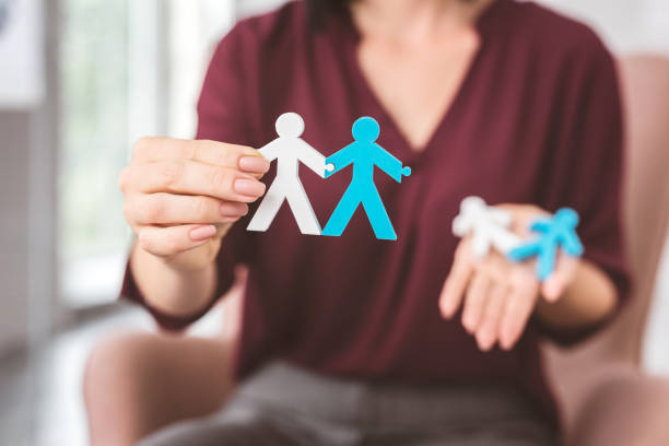 istock Two stickmen holding hands and giving an example of good relationships 1001509852