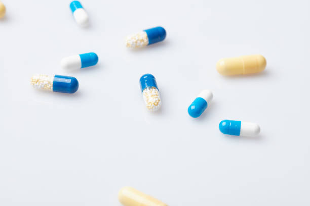 istock A few white round and color pills. 1001509892