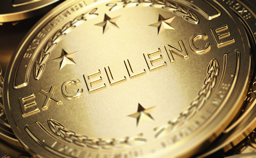 Close up of a golden medal with the word excellence written in relief. Concept of accomplishment. 3D illustration