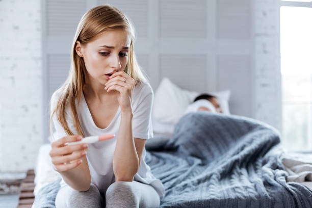 istock Upset woman holding her pregnancy test 1001515868