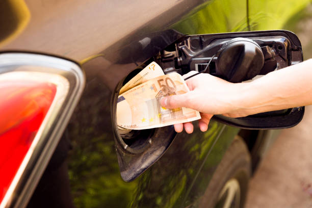Transportation expenses concept - Euro money in car fuel tank stock photo